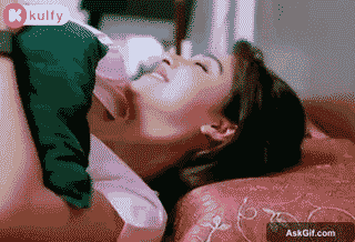 Regina Cassandra Smiles Joyfully While Lying on a Bed