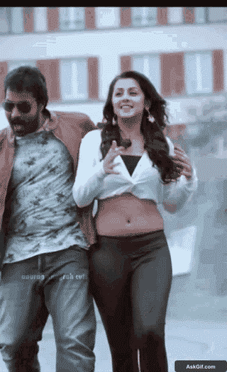 Nikki Galrani Playfully Struts Alongside a Co-Star with a Bright Smile