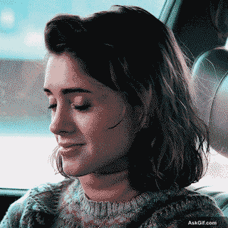 Natalia Dyer Smiles Softly While Sitting in a Car