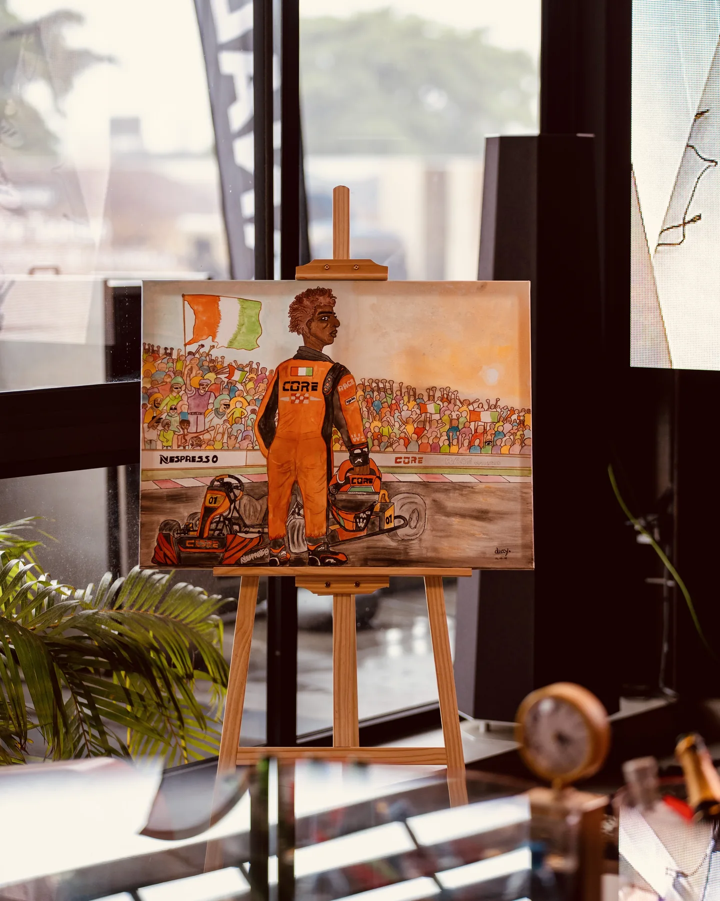 Commissioned motorsport painting displayed on an easel at the venue