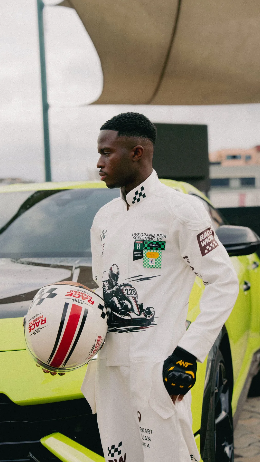 Guest in a bespoke Race Weekend racing suit beside a Lamborghini Urus