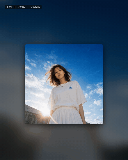 A square clip of a woman under a blue sky grows into a tall 9:16 frame as LTX 2.3 fills in more sky above her and the wall below.