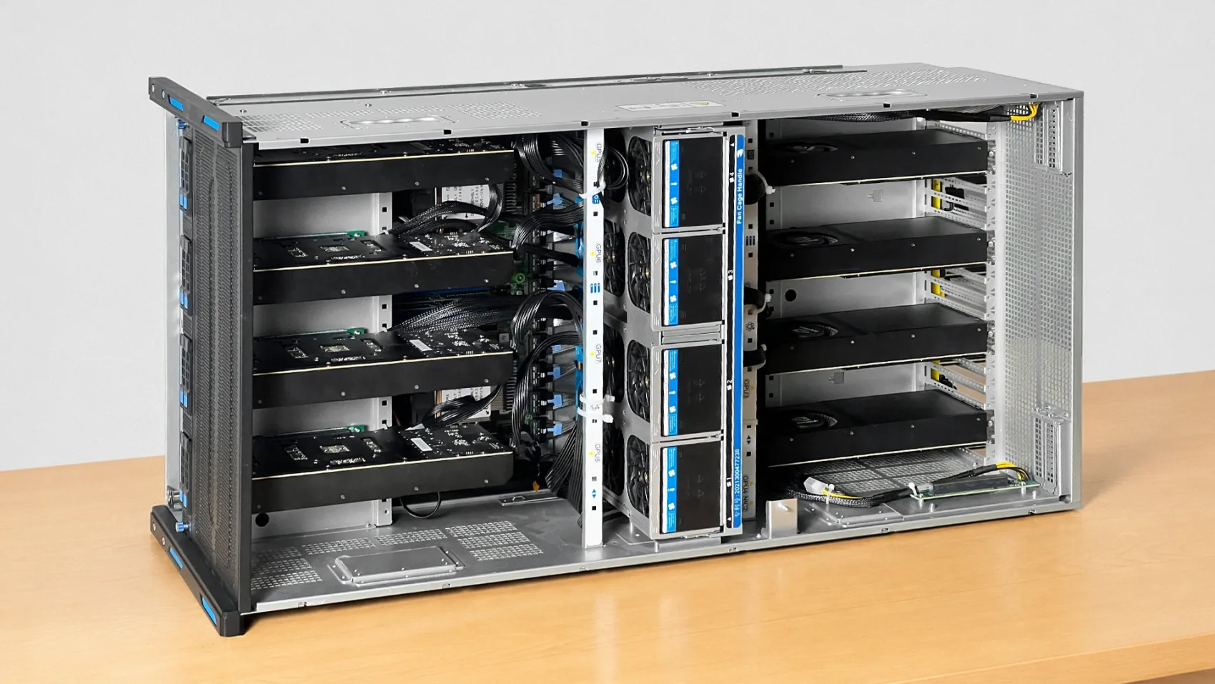 The finished 8× 5090 — 5U rack chassis, top cover off, both GPU columns and the center fan wall