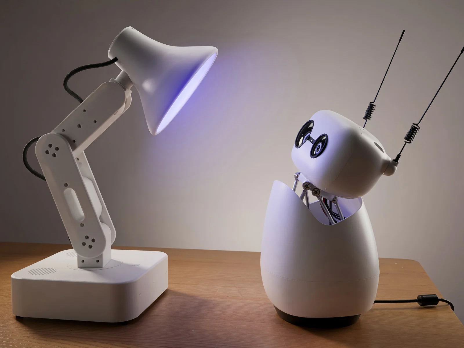 Reachy Mini and Autonomous Lamp side by side on a desk