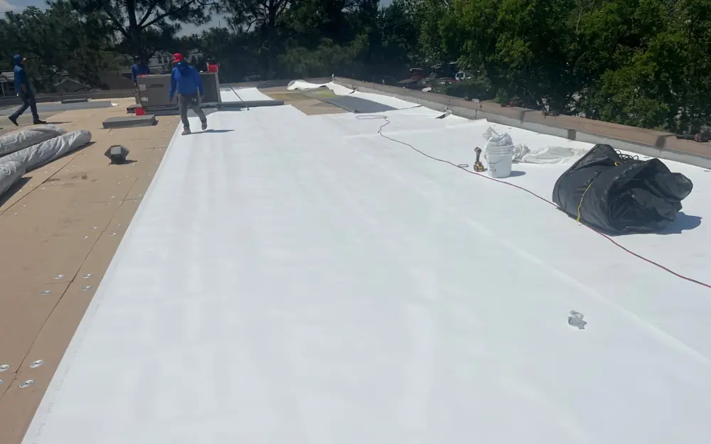 Commercial flat-roof replacement in Houston — new white TPO membrane