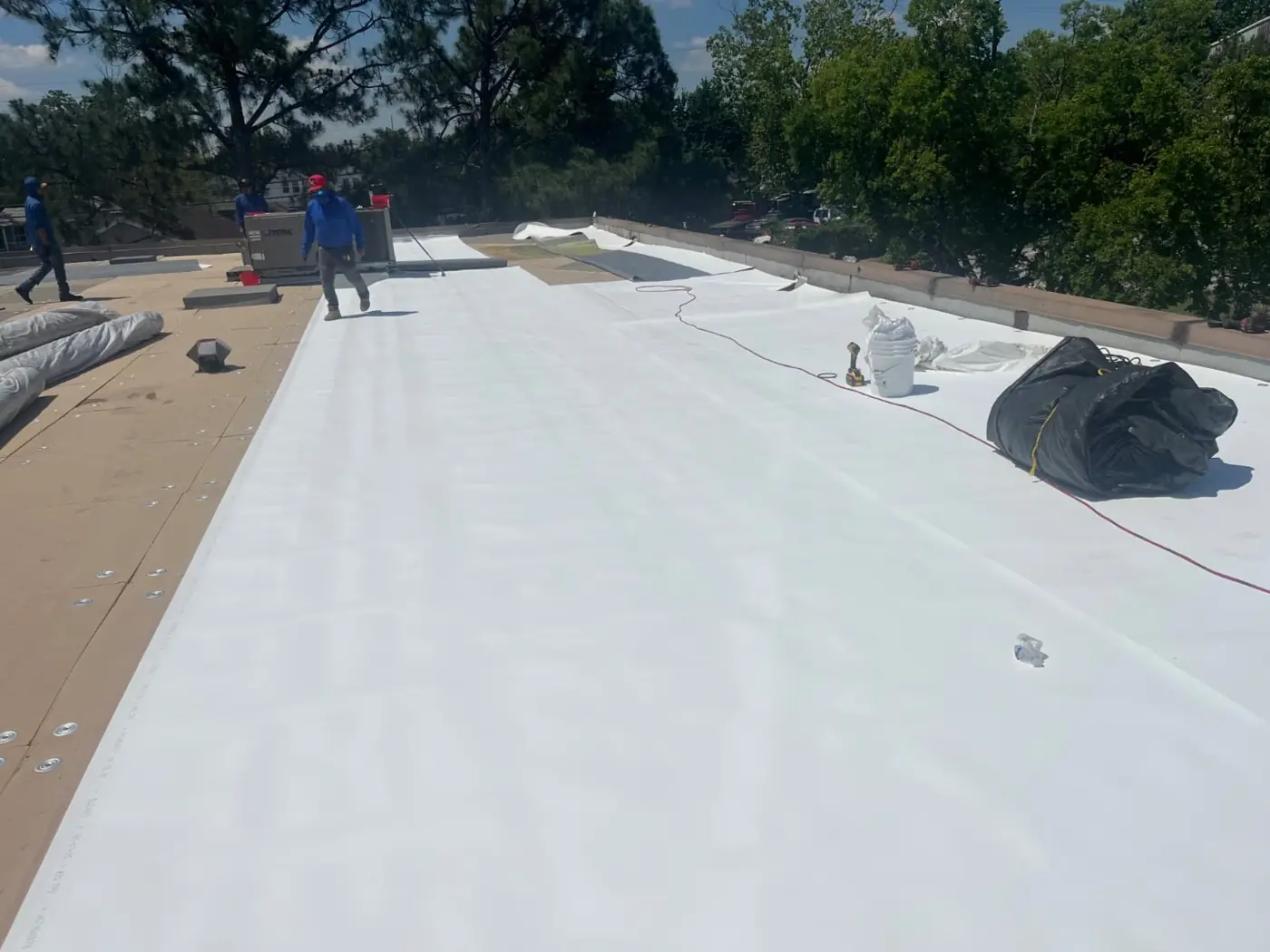 Commercial roof after new reflective white TPO membrane installation in Houston