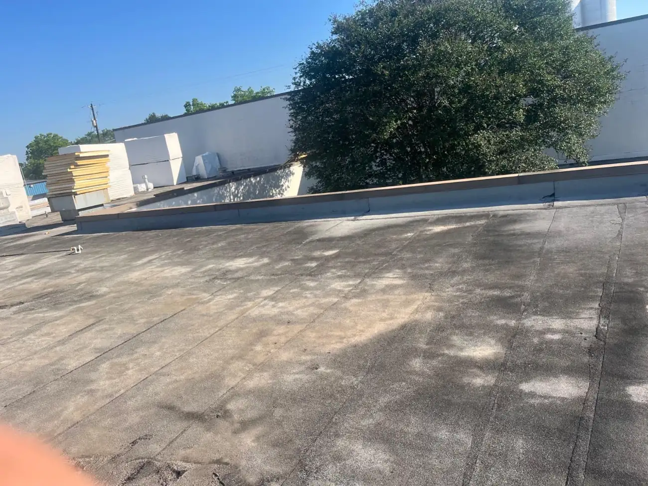 Commercial flat roof before replacement — weathered, repeatedly patched membrane in Houston
