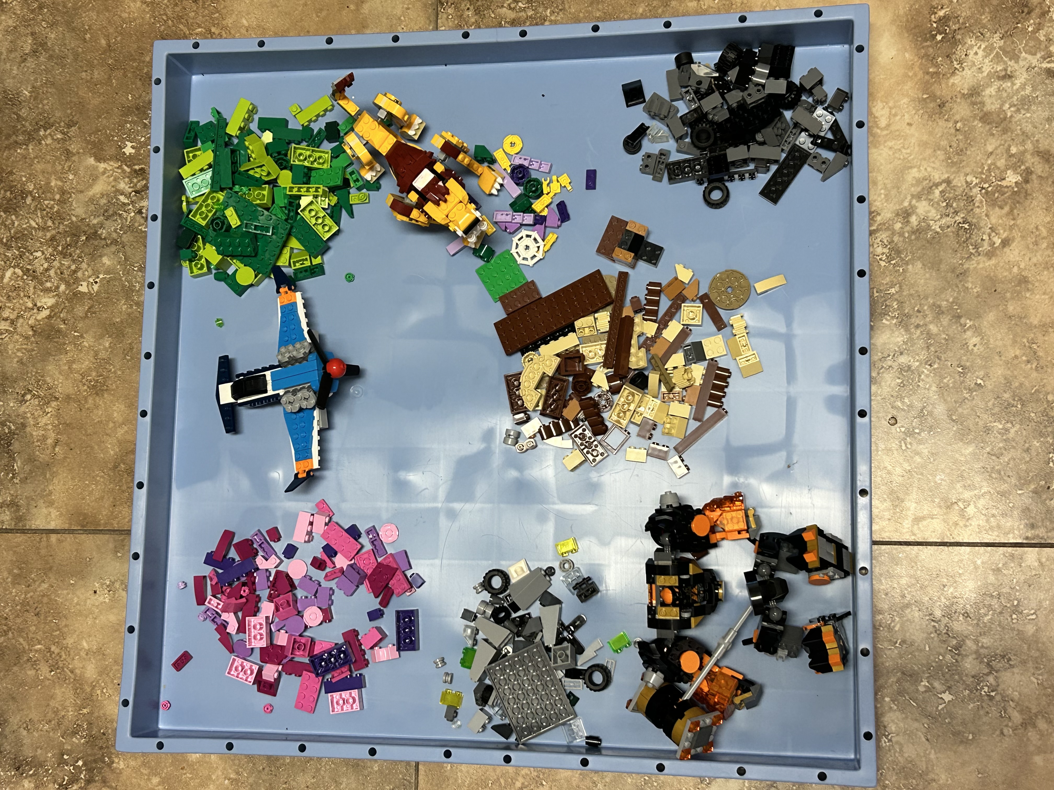 Tools arranged on the Universal Wonder Mat for garage work.