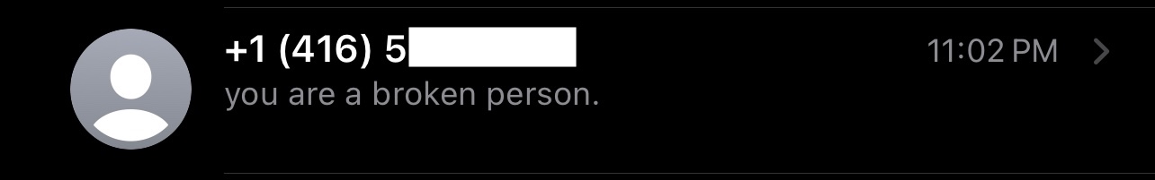 A picture of a conversation in the iOS messages app with a phone number without an associated contact showing the message 'you are a broken person'
