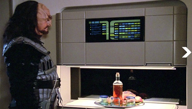 A Klingon visitor using the Enterprise-D’s food replicator in 2368.