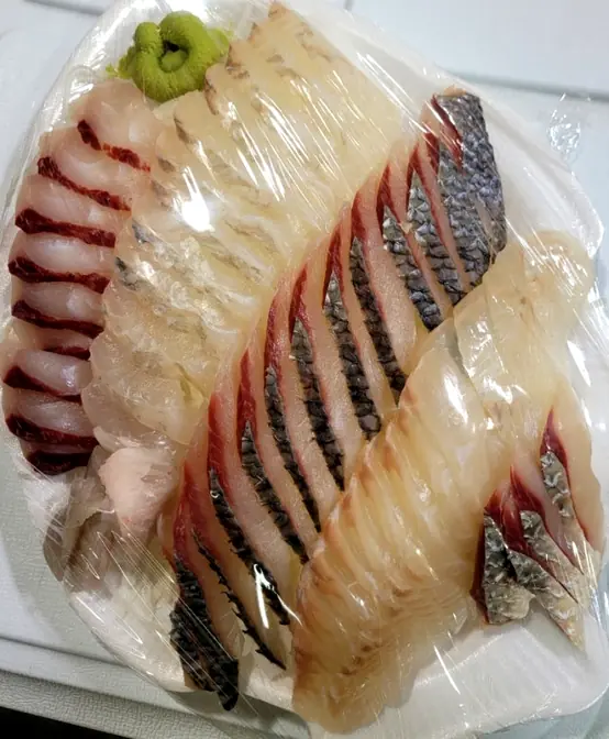 丁寧に包装された高級刺身盛り合わせ