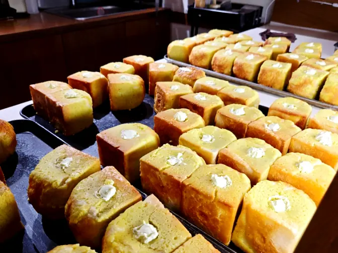 Freshly baked cube breads on trays