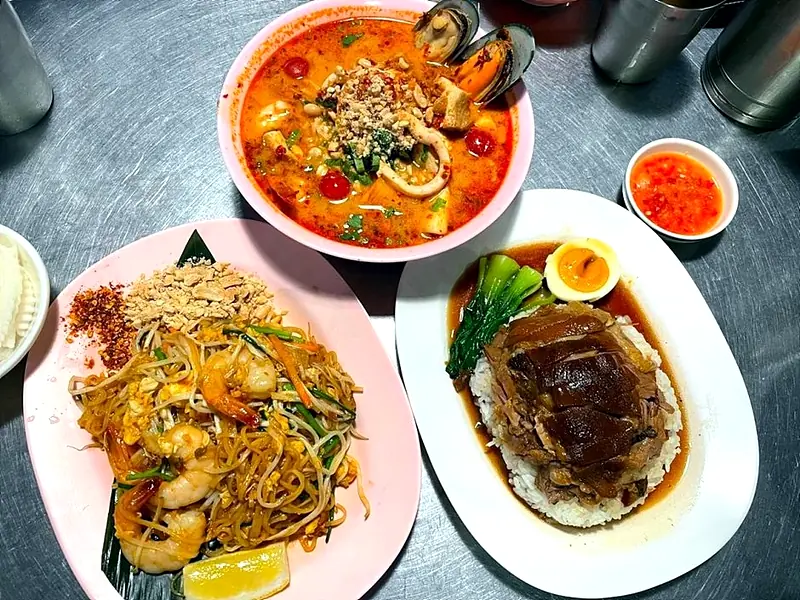 Assorted Thai dishes on metal table