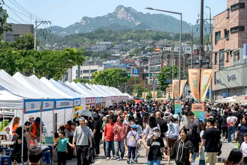 Crowded festival street with tents