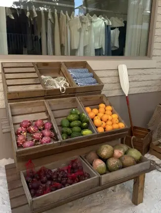Tropical fruit crates on white sand