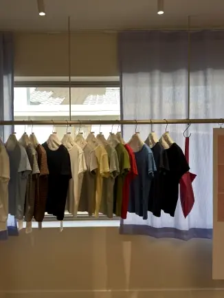 Array of colorful t-shirts on rack