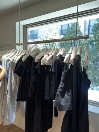 Rows of white clothing on hangers