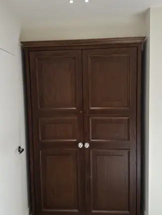 Classic wooden wardrobe in minimalist room
