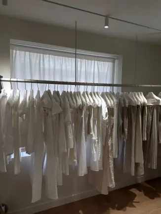 White garments on minimalist clothing rail