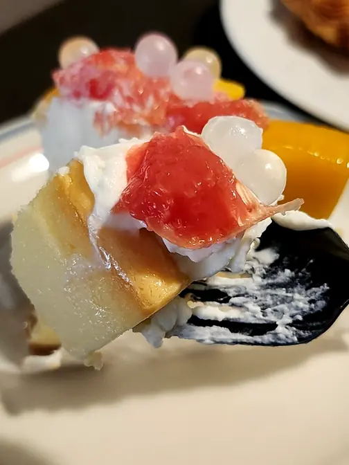 Fork eating fruit cheesecake dessert