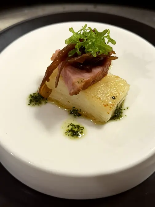 Duck breast appetizer on white plate