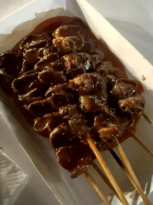 Glazed chicken skewers in tray