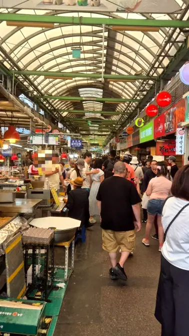 Crowded food alley inside Gwangjang Market