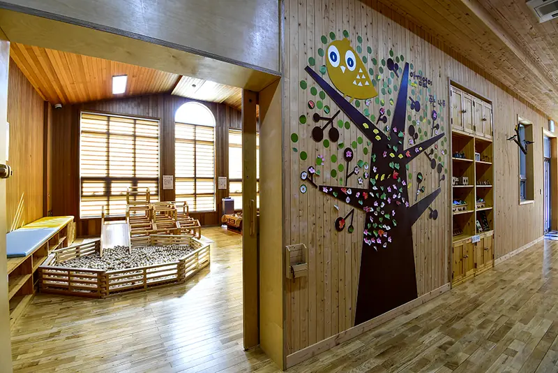 Cozy wooden play area with tree mural