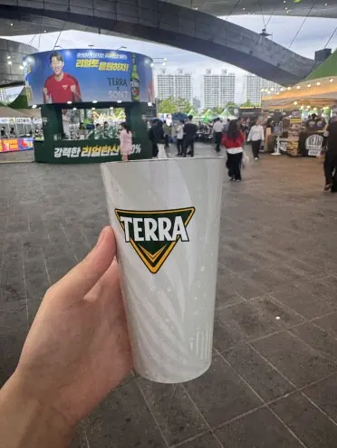 Hand holding Terra draft beer cup