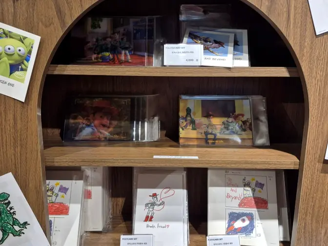 Postcard sets on wooden display shelf
