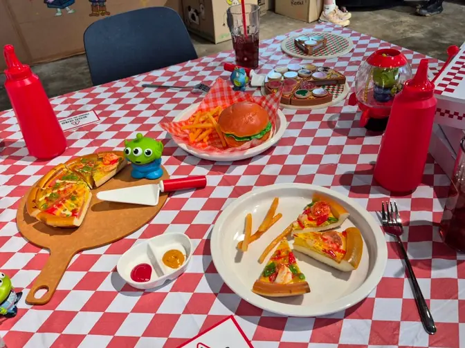Pizza and burger on checkered tablecloth