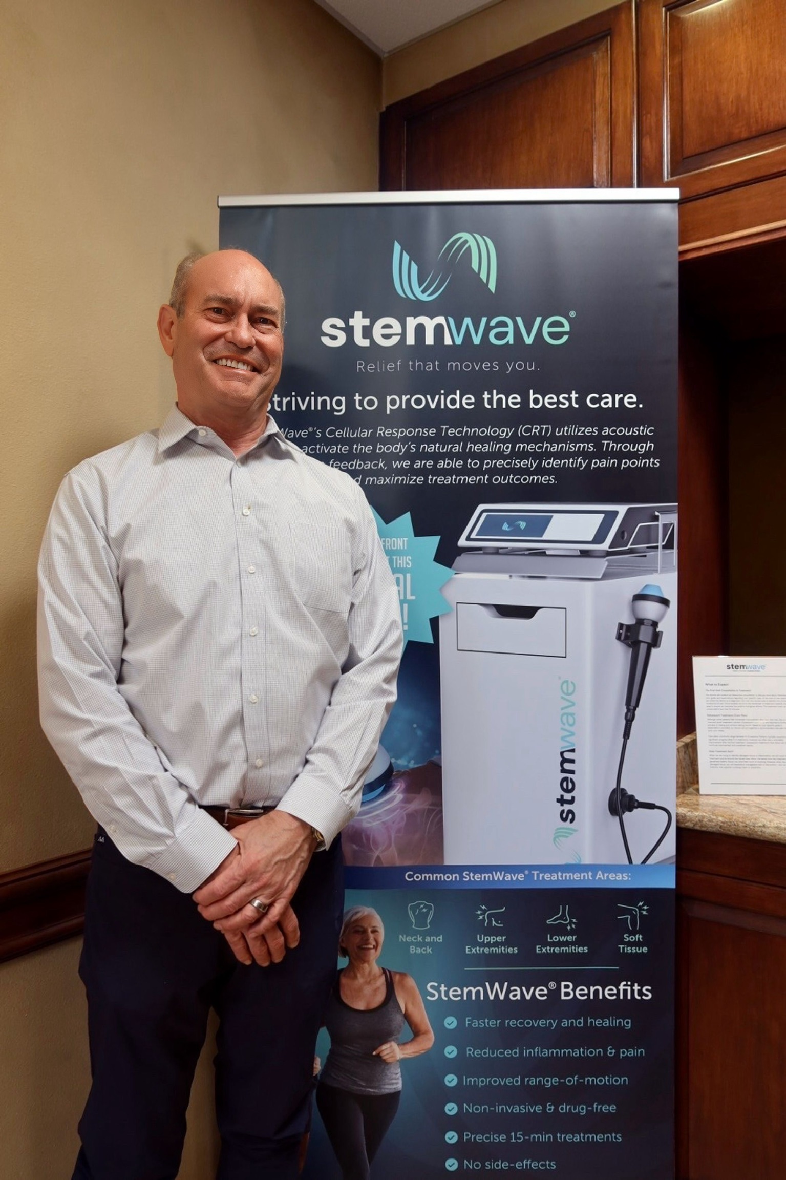Dr. Andrew Burrell standing in front of a StemWave banner