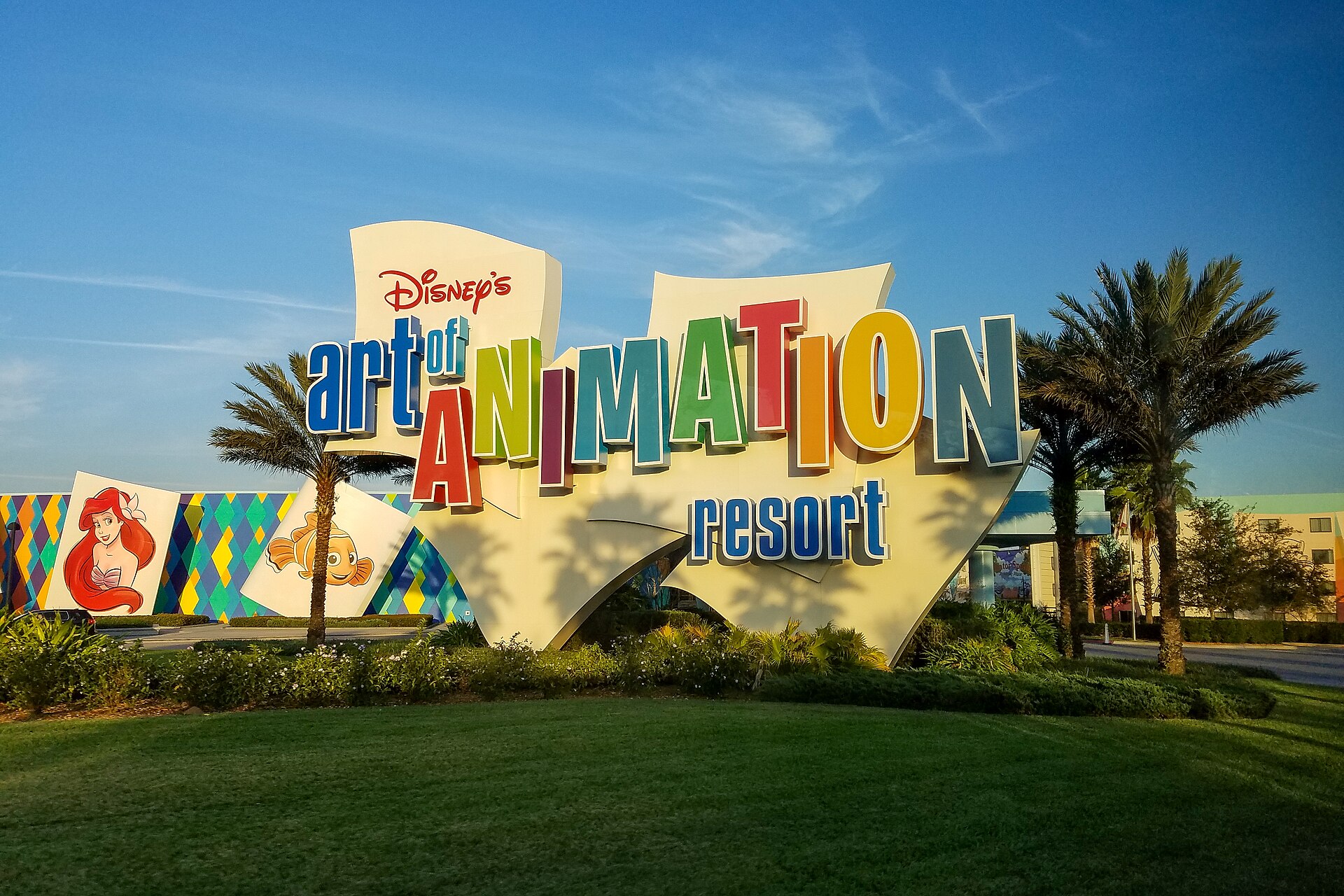 The colorful entrance marquee of Disney's Art of Animation Resort at Walt Disney World, with Ariel and Finding Nemo artwork panels behind it.