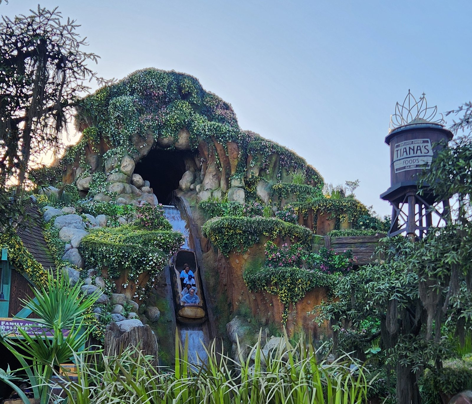 A log descends the chute at Tiana's Bayou Adventure at Disneyland, past the Tiana's Foods water tower.
