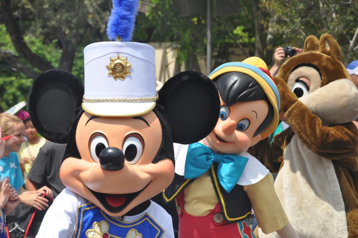 Mickey Mouse and Pinocchio characters greeting guests at a Disney theme park