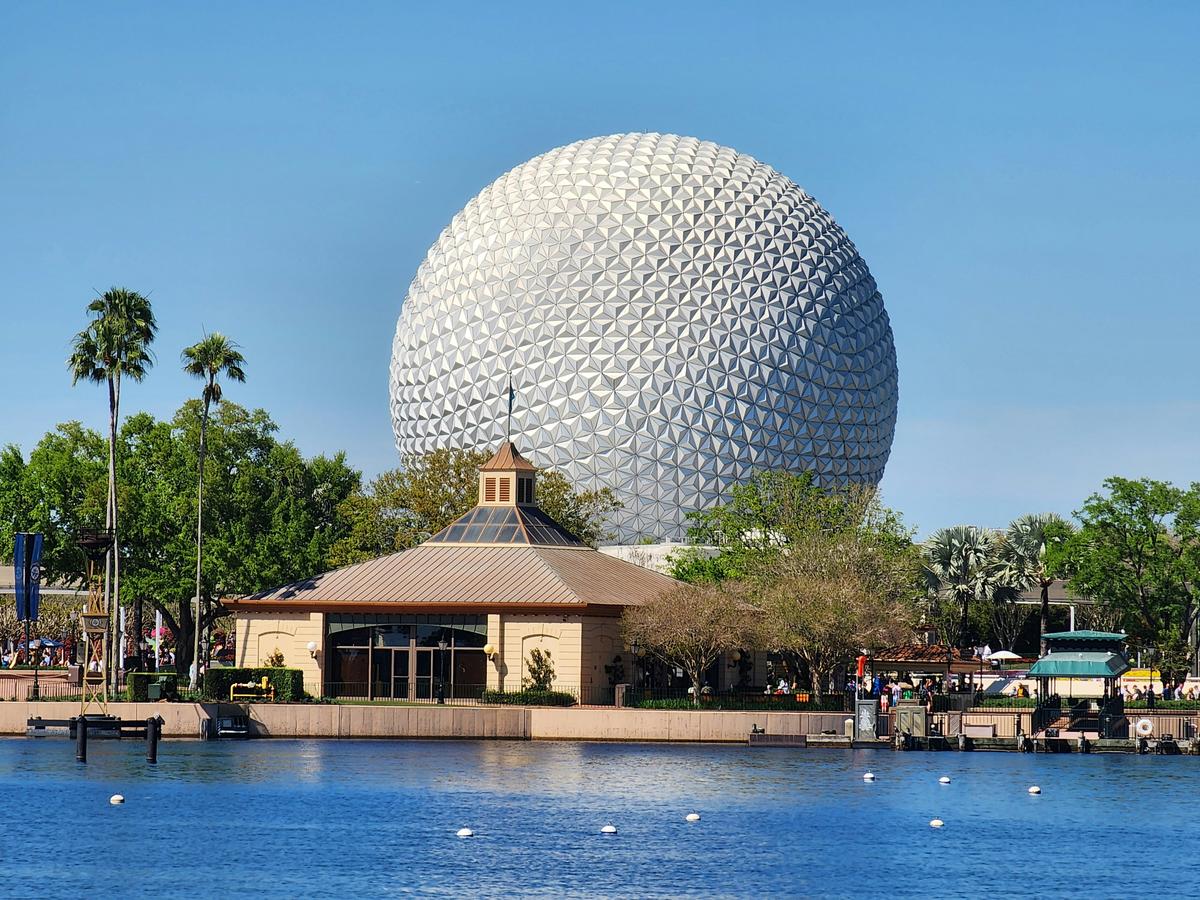 Spaceship Earth at EPCOT seen across the World Showcase lagoon on a clear sunny day