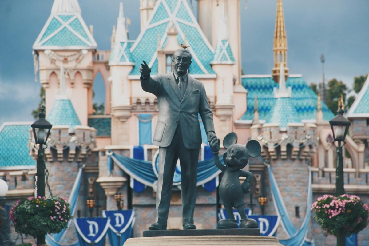 Walt and Mickey Partners statue at Disneyland with Sleeping Beauty Castle in the background