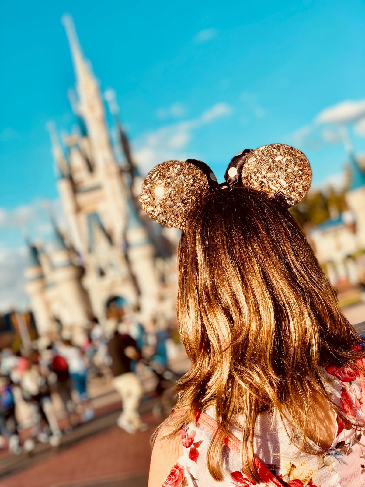 Walt and Mickey Partners statue at Magic Kingdom with Cinderella Castle on a sunny day
