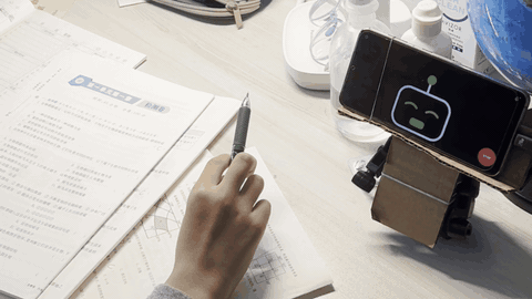 The robot on a desk answering a child's science questions during homework