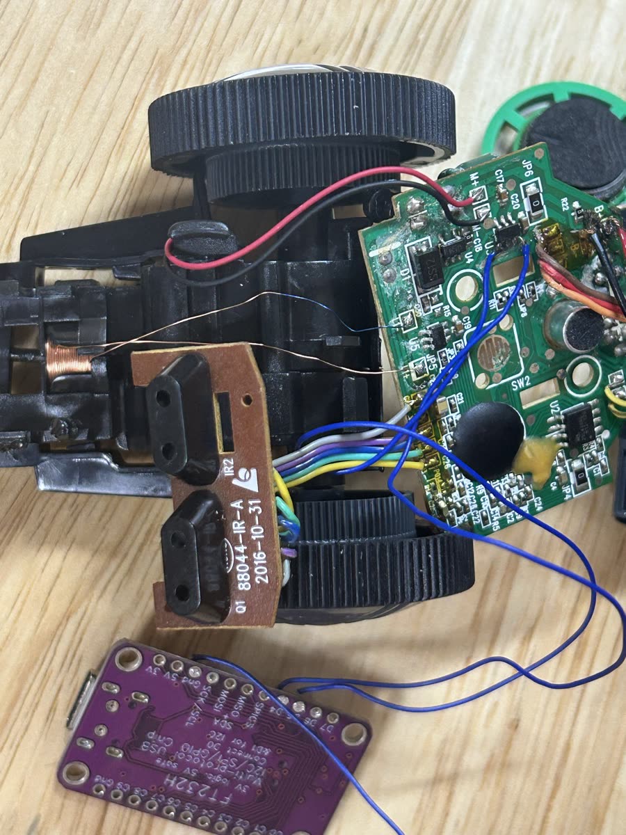The toy's own board with the FT232H wired onto its motor and steering inputs