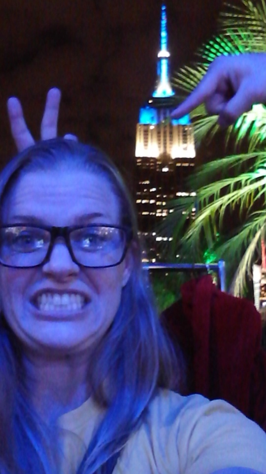 Photograph of Becca's lovely face with the Empire State Building in the background.
