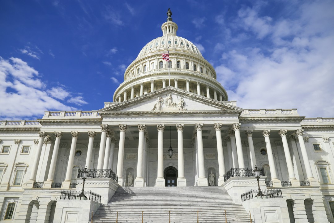 The US Capitol building with its white dome against a blue sky