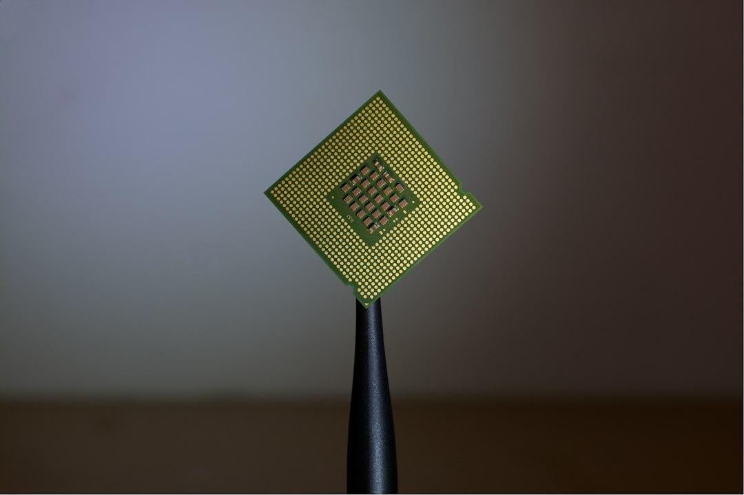 A gold computer processor held upright on a dark stand