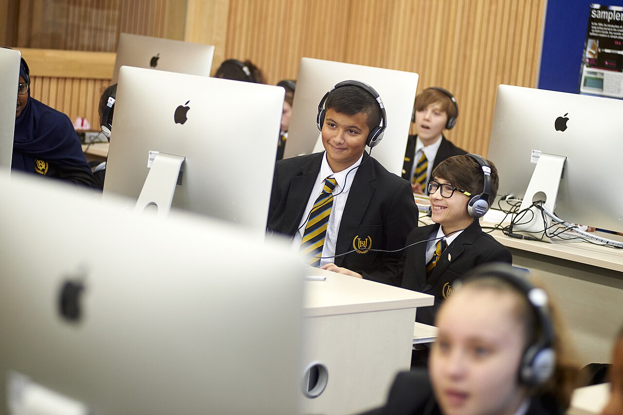 A row of iMacs in a school computer suite