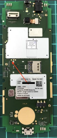 Mainboard of a TA-1307 Nokia 6300 4G, with the red arrow pointing to three gold contacts in the middle of the board