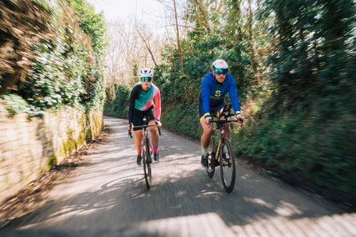 Athletes cycling with a coach