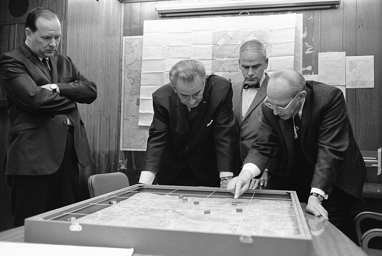 President Johnson and advisers around a terrain model of the Khe Sanh area in the White House Situation Room