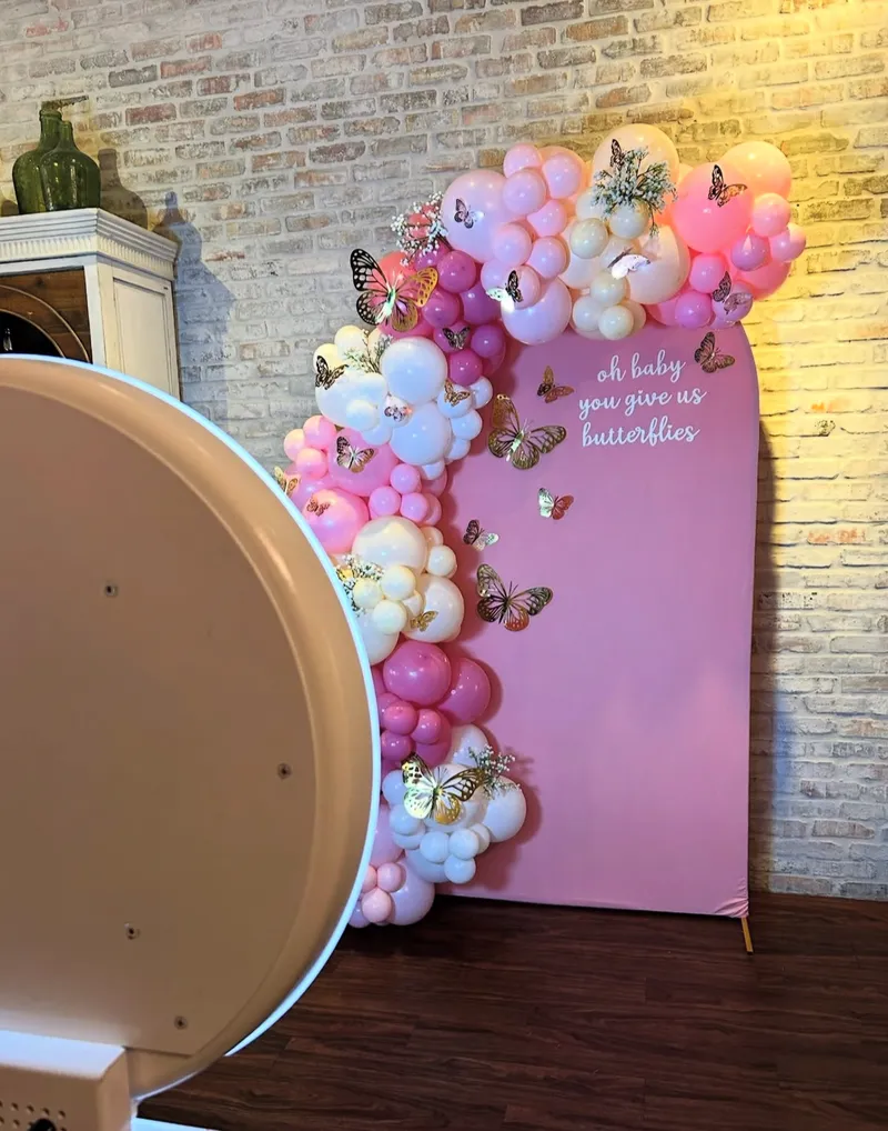 Branded photo booth with balloon decorations at corporate event