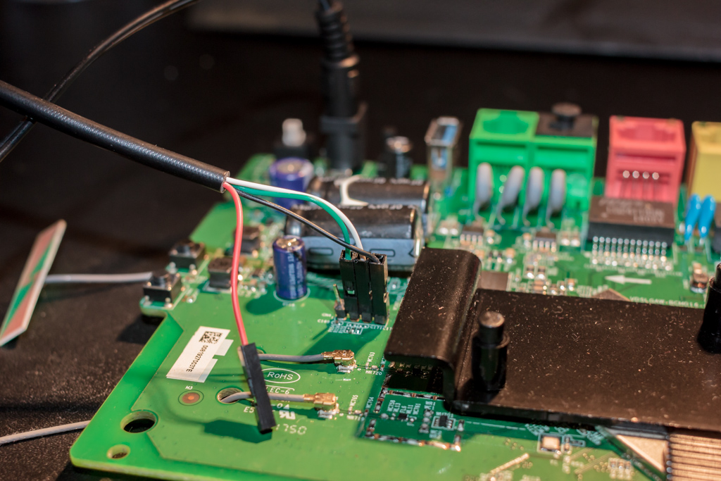 "PCB with UART cable attached to serial pin header"