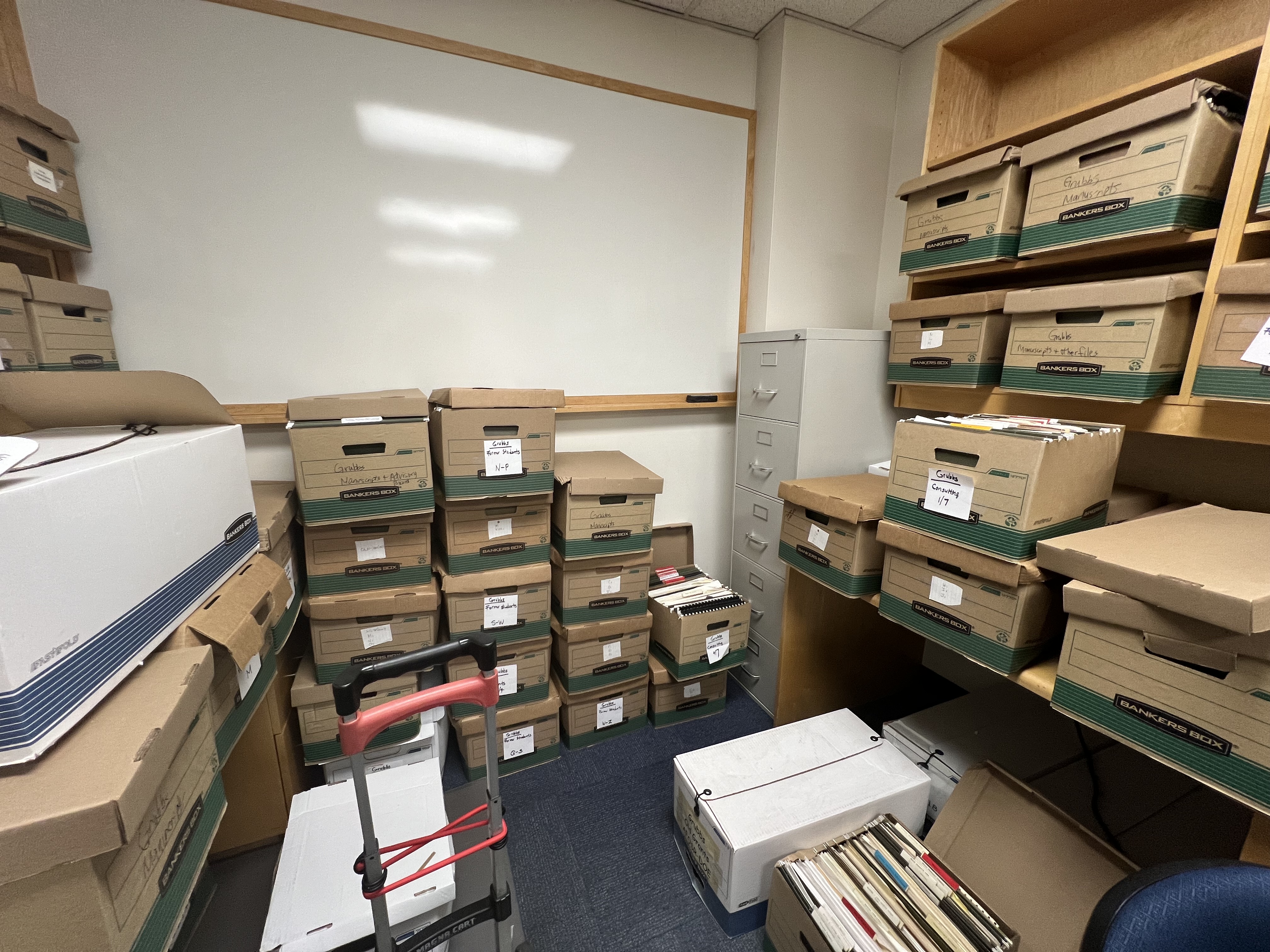 Photo of a room full of banker's boxes containing papers from a faculty member.